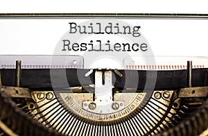 Building resilience symbol. Concept word Building resilience typed on retro old typewriter. Beautiful white background. Business