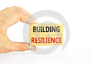 Building resilience symbol. Concept word Building resilience typed on wooden blocks. Beautiful white table white background.