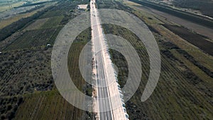 building roads. Aerial flight above new highway lane under construction.