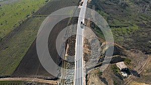 building roads. Aerial flight above new highway lane under construction