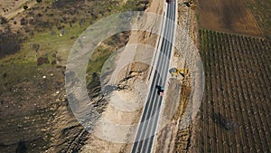 building roads. Aerial flight above new highway lane under construction