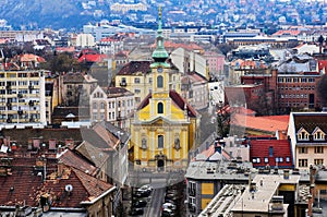building roof tops and streetscape in Budapest in aerial perspective. yellow stucco catholic church facade