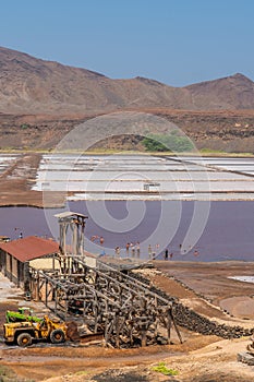 Building at Salinas de Pedra de Lume, old salt lakes with people swimming in the water on Sal Island, Cape Verde photo