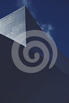 Building with sharp angles light and dark contrast blue sky