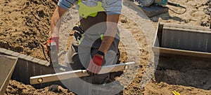 Building a sidewalk - laying decorative curbs by a paving master.