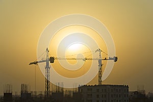 Building site with cranes and blue sky on everning photo