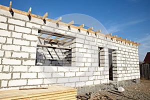 Building site of a house under construction. unfinished house walls made from white aerated autoclaved concrete blocks. outside