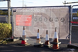 Building site open with covid-19 safety sign at entrance