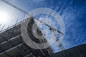 Building site with scaffolding and construction crane.