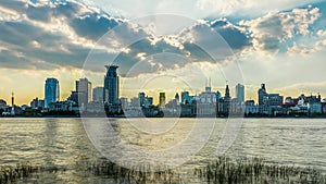 Building skyline and river water surface with sky cloudscape