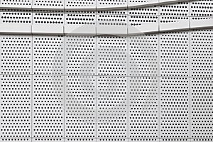 Building with steel sheet pegboard or orderly holes wall photo