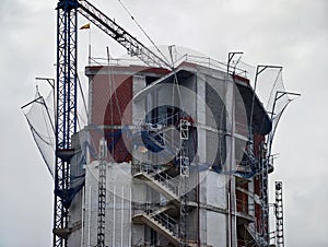 Building Structure With Safety Features, Exterior Stairwell And Protective Netting In Construction