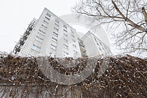 Building of student hostel in Russian industrial district, cloudy winter day