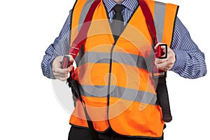 Building Surveyor in orange visibility vest putting on safety harness