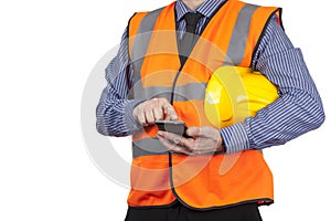 Building Surveyor in orange visibility vest using his smartphone