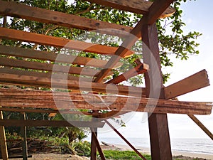 Building a tiny wooden house on the beach side.