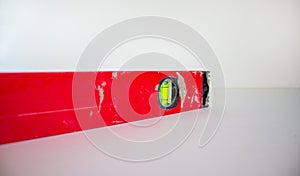Building tool level. Red water level tool isolated on white background. Concept. Copy space