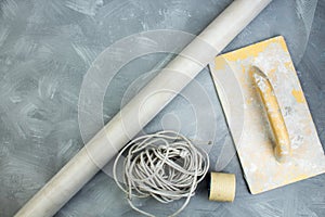 Building tools on the gray concrete background. Copy space. Top view