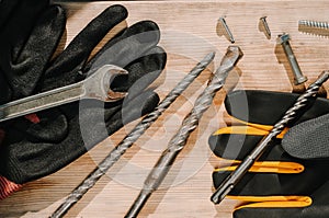 Building tools including centimeter ruler, wrench and cutter placed in the right side on wooden surface with open space. Top view photo