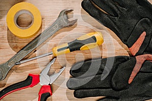 Building tools including centimeter ruler, wrench and cutter placed in the right side on wooden surface with open space. Top view