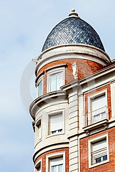 Building with a tower and domed roof. Spanish architecture. photo