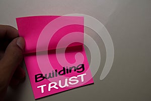 Building Trust write on a sticky note isolated on office desk