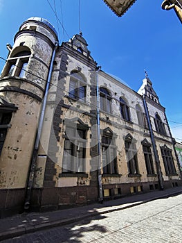 The building with a turret, finished with granite, built in 1890, on a sunny summer day in Vyborg