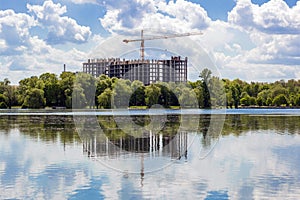 Building under construction on the bank of big lake