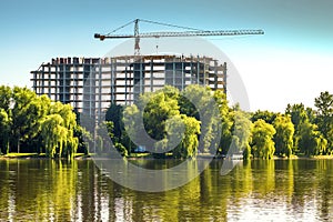 Building under construction on the bank of big lake