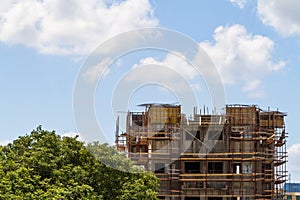 Building under construction, blue sky with clouds