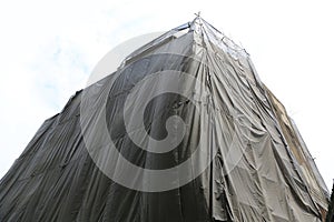 Building under construction with covered by black canvas