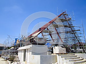 The building is under construction, roof steel frame.