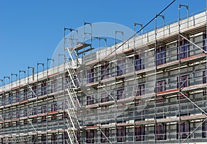 Building under construction - scaffolding at the facade