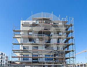 Building under construction - scaffolding at the facade