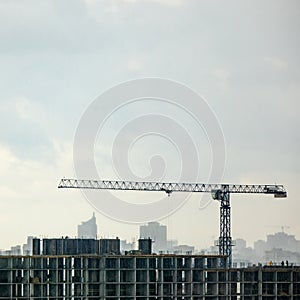 Panoramic photo from the drone of building under construction with crane against a cloudy sky.