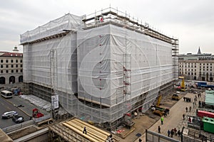 Building under refurbishment with construction plastic covering