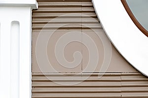 Building wall brown color with horizontal stripes, elements of facade - pilasters of simple shapes. photo