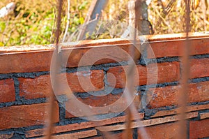 Building a wall with red brick. Working with bricks for building a wall, Construction tools