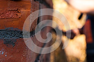 Building a wall with red brick. Working with bricks for building a wall, Construction tools