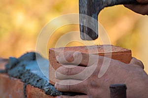 Building a wall with red brick. Working with bricks for building a wall, Construction tools
