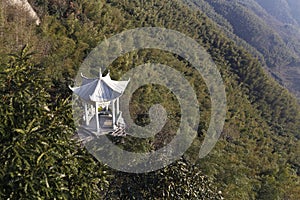 Building of white stone pavilion halfway up the mountain