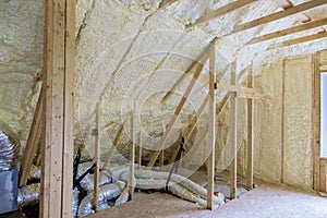 Building with wooden beams of a roof installing pipe heating system