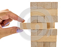 Building from wooden blocks. Wood blocks stack game with Hand on background. Conceptual of Teamwork