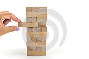 Building from wooden blocks. Wood blocks stack game with Hand on background. Conceptual of Teamwork