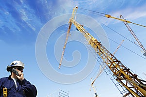 Building worker, cranes and scaffolding