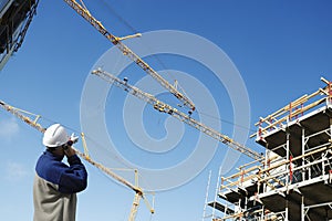 Building worker, cranes and scaffolding