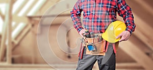 Building worker with tool belt and helmet