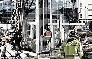 Building workers with mobile cranes