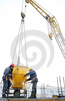 Building workers pouring concrete