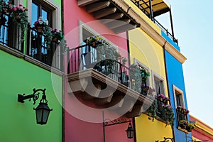 Buildings with beautiful windows, balconies and potted flowers